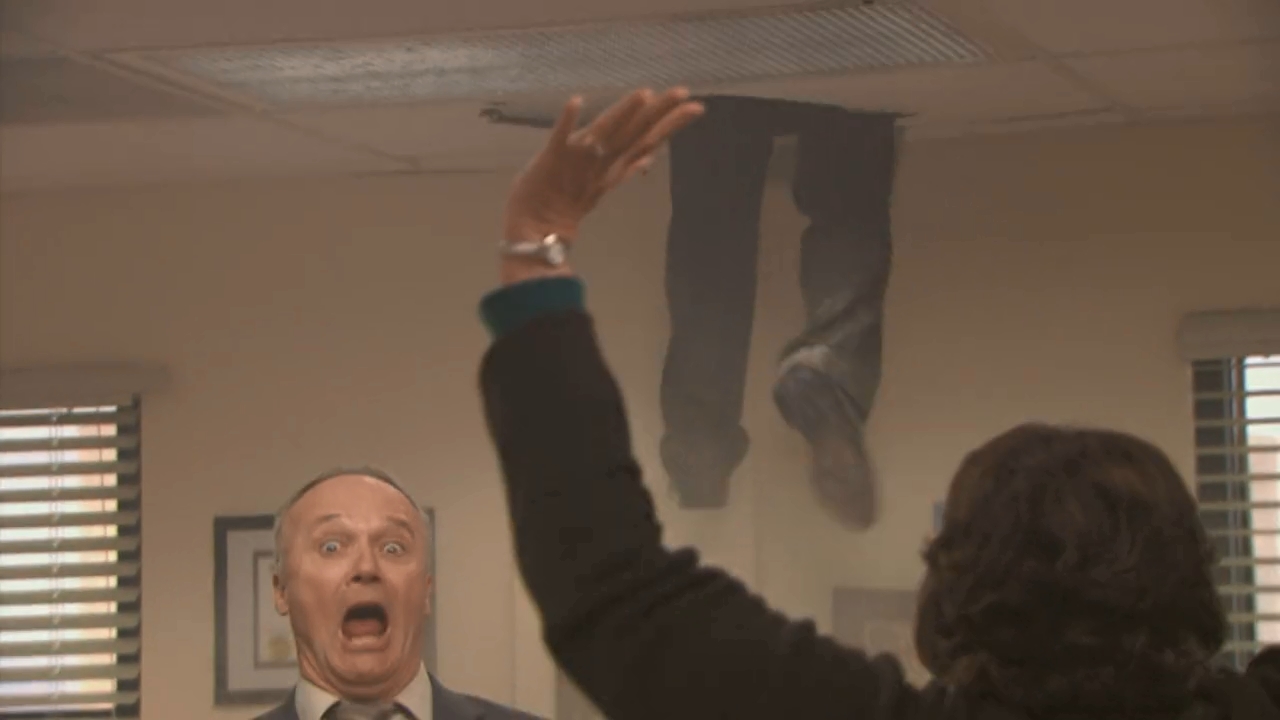 Screenshot from season 5 episode 13, from the scene where Oscar falls from the ceiling and Creed reacts with a frightened face